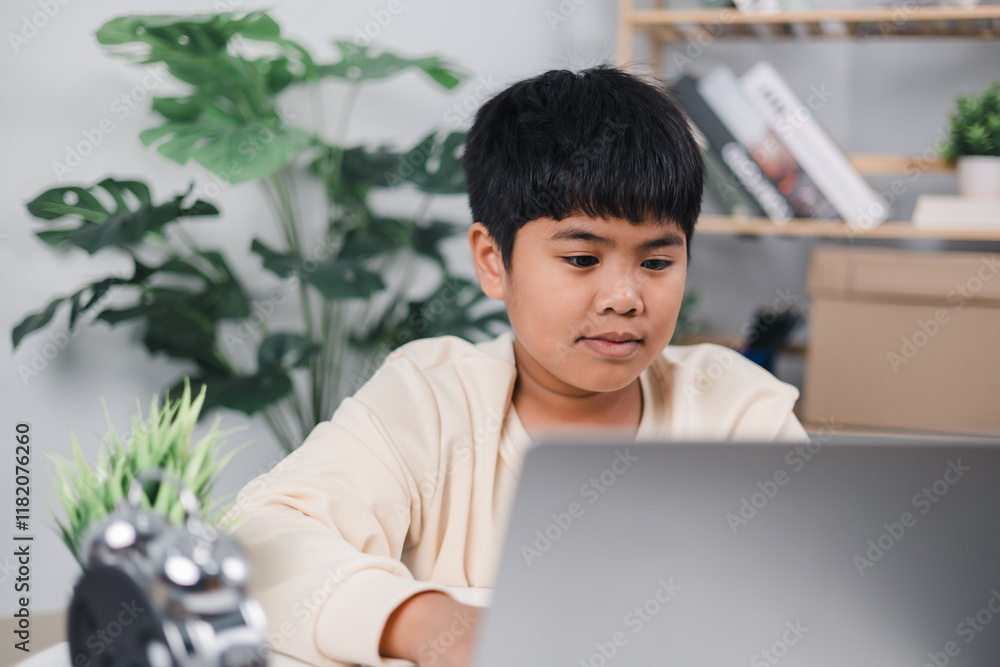 Educational of tech concept, Presenting a modern educational way of life, Little Asian boy student using computer laptop learning, Staying at home, Virtual internet online class from school teacher. Educational of tech concept, Presenting a modern educational way of life, Little Asian boy student using computer laptop learning, Staying at home, Virtual internet online class from school teacher.