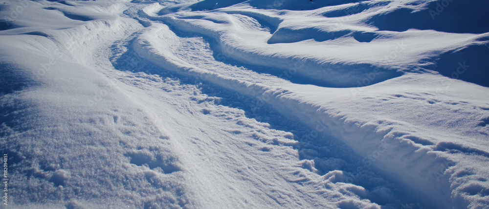 Ski tracks winding through pristine snow covered mountains during winter Ski tracks winding through pristine snow covered mountains during winter