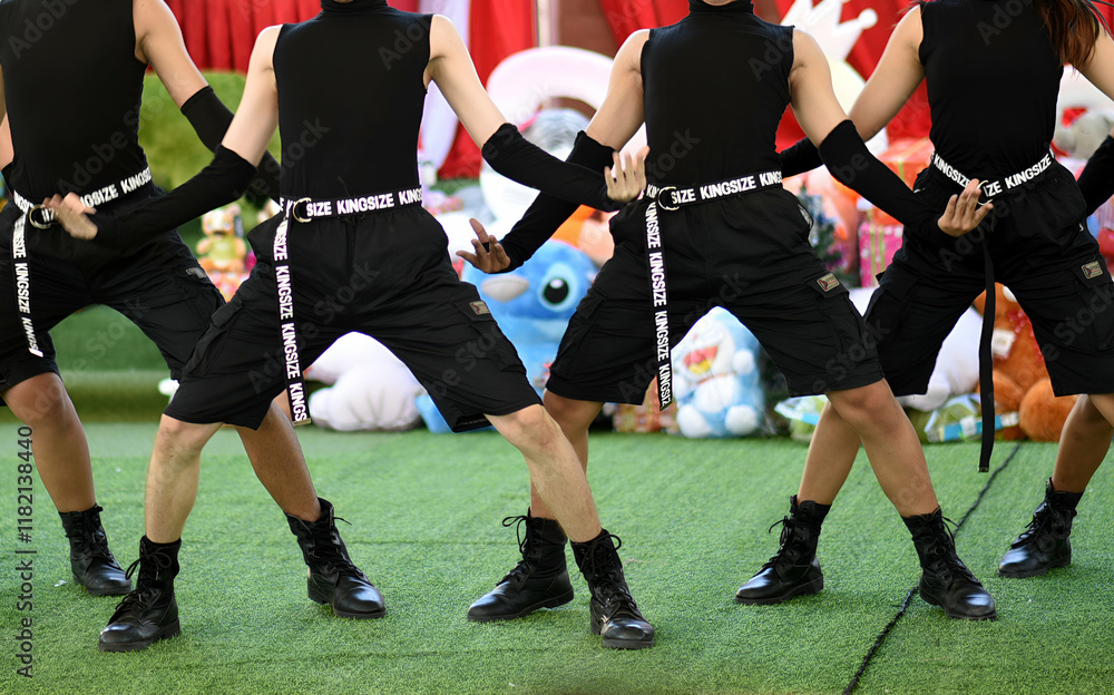 Four people are dancing on a green field Four people are dancing on a green field