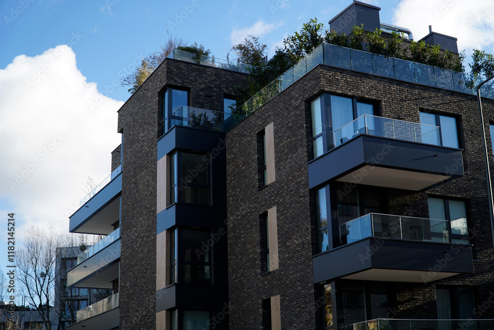Modern residential building with balconies and dark brick elevation Modern residential building with balconies and dark brick elevation