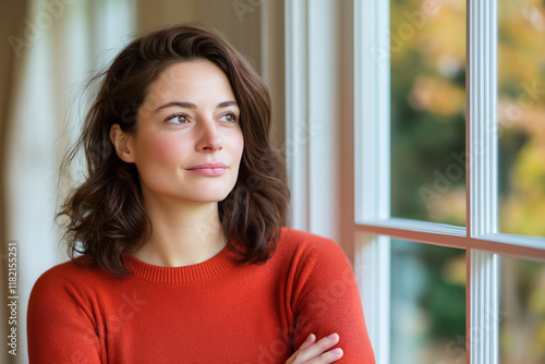 Free Download thoughtful woman gazes out window, lost in contemplation. Her warm expression and cozy sweater create serene atmosphere, reflecting moment of introspection - GFXLoad