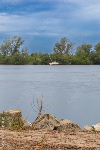 The landscape photo of a partially felled boat at the Anclote River Park the ripples of the water provide a timeless feel photo