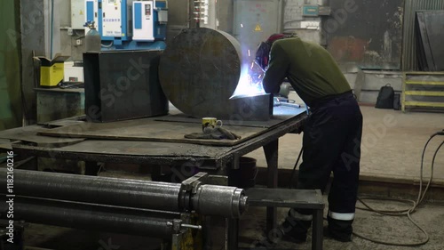 Welder works in a turning workshop