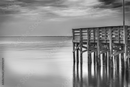 The pier extends over the calm Anclote River Park the ripples of the water provide a timeless feel. Tarpon Springs FL 2024