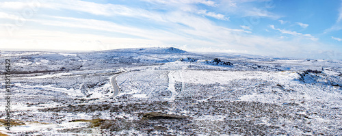 Dartmoor view taken from Haytor rock on Dartmoor on a snowy winters day. Panoramic picture showing the granite moorland taken in the Dartmoor National park in Devon. photo