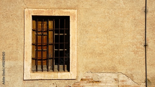 wooden window in facade with grate as background photo