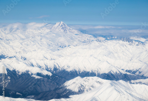 Beautiful airplane view of Mount Kazbek and the Caucasus Mountains on a sunny winter day photo