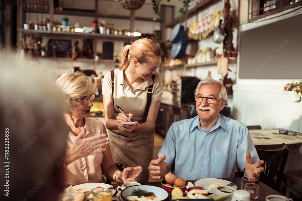 Waitress serving senior friends enjoying breakfast in a cozy cafe Waitress serving senior friends enjoying breakfast in a cozy cafe