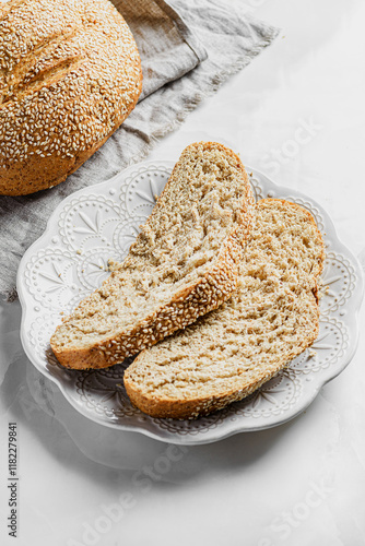 freshly baked round bread with sesame seeds photo