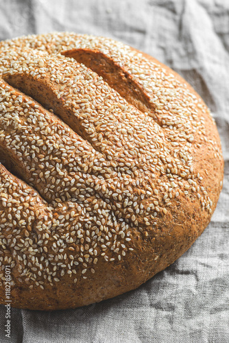 freshly baked round bread with sesame seeds photo