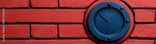 Red Brick Wall with Blue Circular Vent: A close-up shot of a dark blue, circular vent set against a backdrop of a rich red brick wall. The texture of both the brick and metal are sharply defined. photo