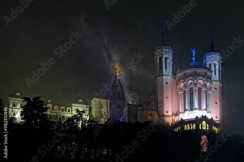 LYON, December 8, 2024 : Fourviere basilica in the fog during the Fete des Lumieres. Festival reveals the beauty of Lyon at nightfall every year around december 8th.