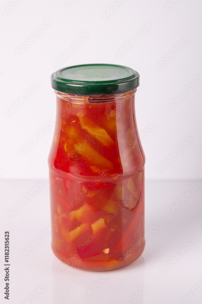 lecho from peppers and tomatoes in a glass jar on a white background, mock-up lecho from peppers and tomatoes in a glass jar on a white background, mock-up