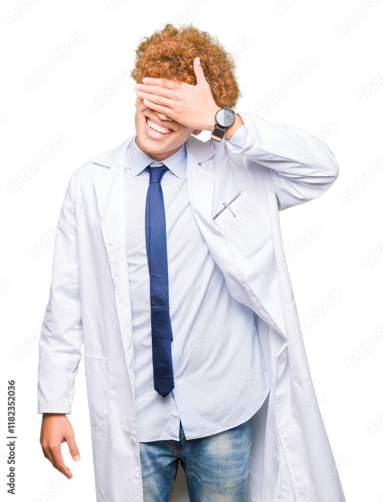 Young handsome scientist man wearing glasses smiling and laughing with hand on face covering eyes for surprise. Blind concept. Young handsome scientist man wearing glasses smiling and laughing with hand on face covering eyes for surprise. Blind concept.