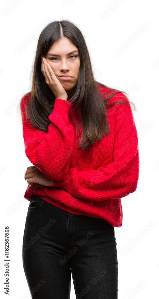Young beautiful hispanic wearing red sweater thinking looking tired and bored with depression problems with crossed arms. Young beautiful hispanic wearing red sweater thinking looking tired and bored with depression problems with crossed arms.
