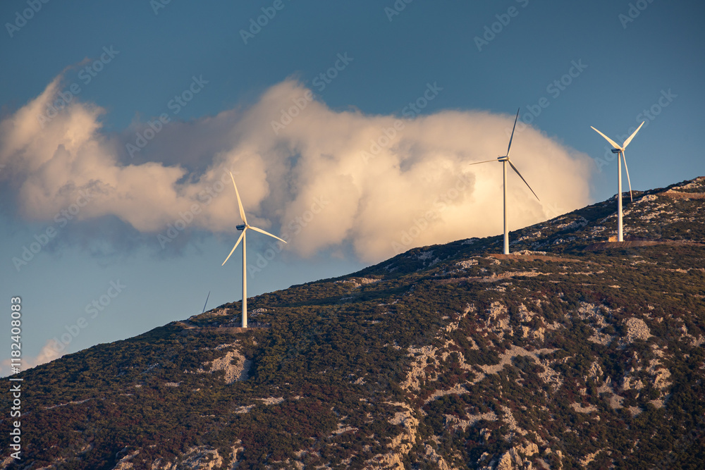 Wind turbines on the hills of Greece. Industrial concept photo for wind mills that produce electricity from wind power. Wind turbines on Parnassus mountain hills in Greece. Green energy.