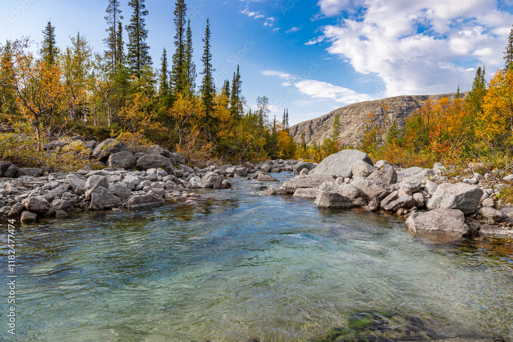 Mannepakhp river with a little whirlpool crystal cold water. Early autumn in arctic tundra region Khibiny mountains. Kola peninsula, Murmansk region, Russia.