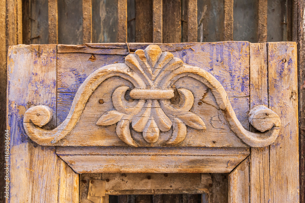 Old Cairo, Cairo, Egypt. Carved decoration on a weathered antique door. Old Cairo, Cairo, Egypt. Carved decoration on a weathered antique door.