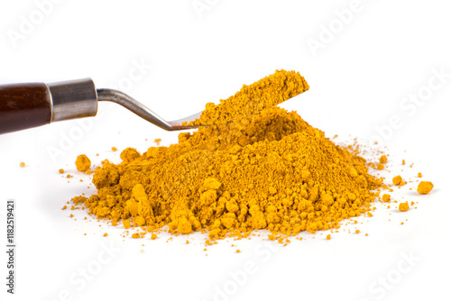 light ocher pigment Powder Spilled From a Container With a Smooth, Rich Texture on a Bright Background
