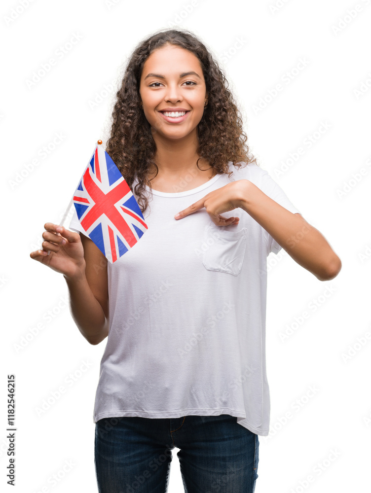 Young hispanic woman holding flag of United Kingdom with surprise face pointing finger to himself Young hispanic woman holding flag of United Kingdom with surprise face pointing finger to himself
