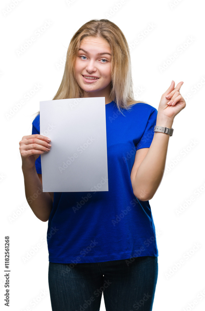 Young caucasian woman holding blank paper sheet over isolated background very happy pointing with hand and finger to the side Young caucasian woman holding blank paper sheet over isolated background very happy pointing with hand and finger to the side