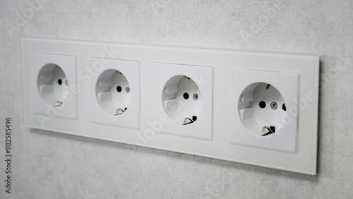 Four empty European wall outlets photo