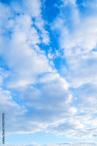 Blue sky view, picturesque blue sky background with scenic fluffy clouds, vertical blue sky landscape