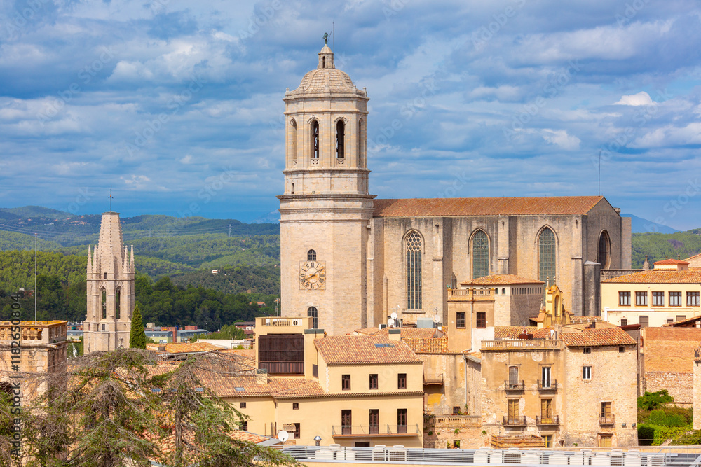 The bell tower of the cathedral rises above traditional stone buildings Spain, Catalonia The bell tower of the cathedral rises above traditional stone buildings Spain, Catalonia