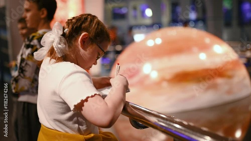 a child studies an exhibit in a museum, a planets , meteorite. High quality 4k footage
