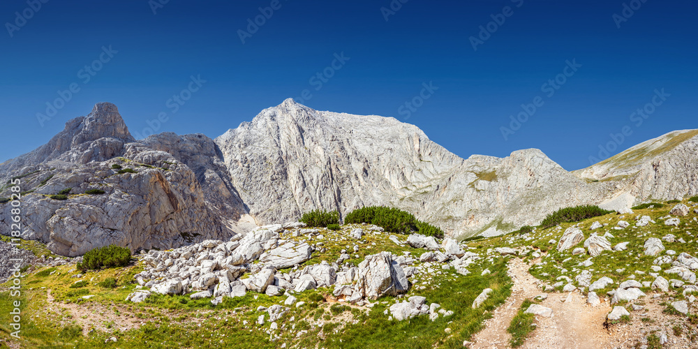 Panorama of the Pirin highlands in summer sunny day. Mt. Vihren and Dzhamdzhievi rocks, view from Kazana shelter in Pirin national park, Bulgaria. Panorama of the Pirin highlands in summer sunny day. Mt. Vihren and Dzhamdzhievi rocks, view from Kazana shelter in Pirin national park, Bulgaria.