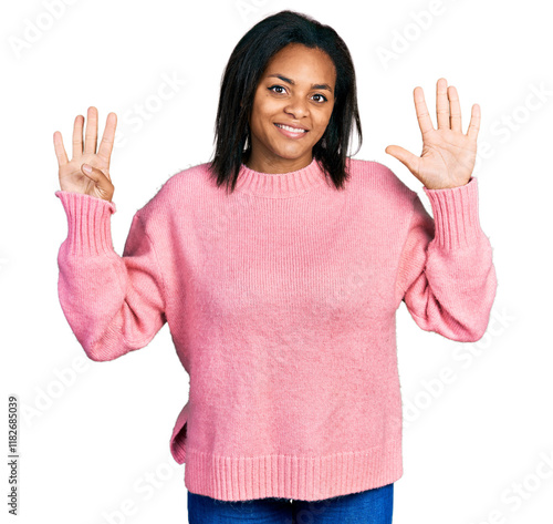 Beautiful hispanic woman wearing casual winter sweater showing and pointing up with fingers number nine while smiling confident and happy.