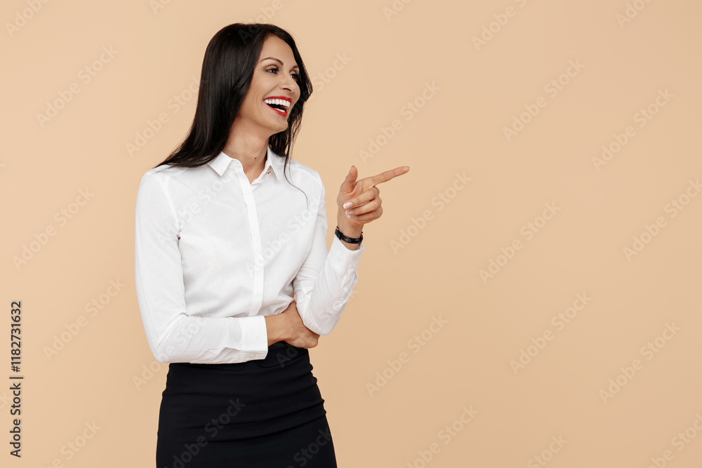 Smiling young modern business woman pointing finger away over beige background. Smiling young modern business woman pointing finger away over beige background.