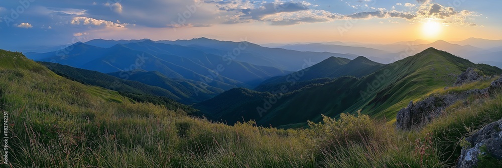 Fototapeta premium A breathtaking view of mountains under a colorful sunset sky.