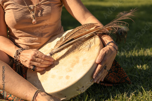 young woman playing shamanic drum