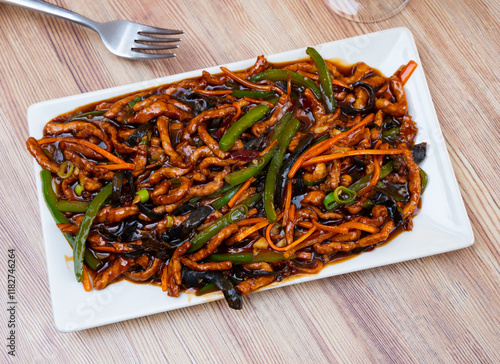 Chinese cuisine dish - appetizing yuxiang shredded pork with carrots and green beans served on plate photo