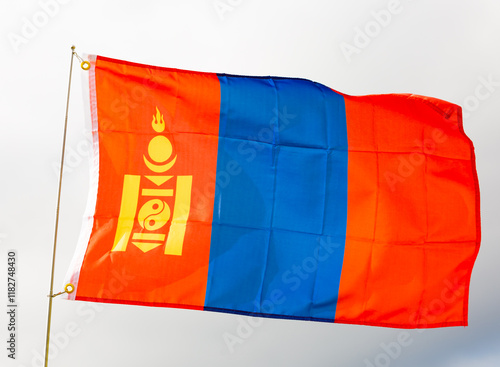 Flag of mongolia flying proudly in wind with sky as background photo