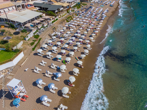 Agios Gordios exotic beach in Corfu island,Greece. Agios Gordios beach, Corfu island, Greece. Panoramic view of the Agios Gordios beach, sandy seashore with beach umbrellas and deck chairs. photo