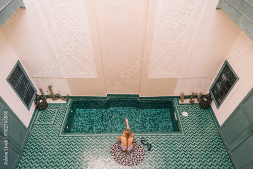 Woman Relaxing by Moroccan Pool photo