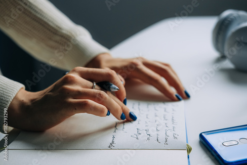 Close-Up of Hands Journaling in Notebook photo