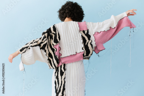 Woman in Colorful Knitwear Posing with Outstretched Arms photo