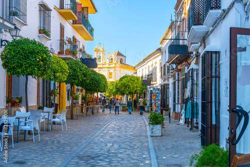 Calle Ronda, the main street of shops and cafes in Zahara de la Sierra, Spain, one of the famous white villages of the Andalusian region of Southern Spain. photo