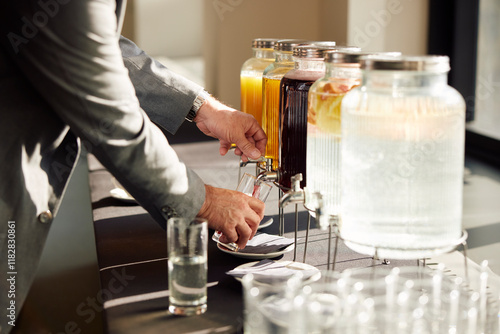 Pouring juice from a dispenser