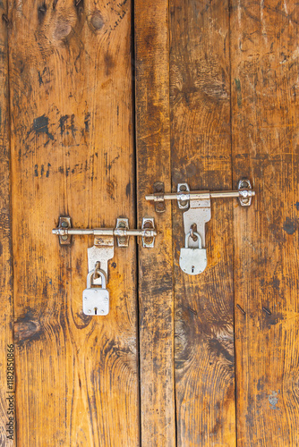 Berna Bugh, Kangan, India. Padlocks on a weathered wooden door. photo