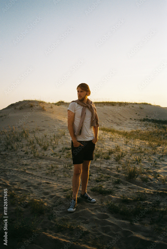 A bearded man standing in the desert A bearded man standing in the desert
