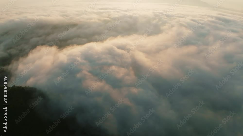 Amazing sea of fog move flowing over mountains, Sunrise sky,Aerial view Drone flies over clouds, Rainforest Clouds and fog in sunrise light, Nature and travel background concept Amazing sea of fog move flowing over mountains, Sunrise sky,Aerial view Drone flies over clouds, Rainforest Clouds and fog in sunrise light, Nature and travel background concept