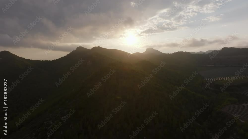 Golden sunlight bathing verdant mountain peaks, casting warm glows across serene landscape during late evening twilight hour Golden sunlight bathing verdant mountain peaks, casting warm glows across serene landscape during late evening twilight hour