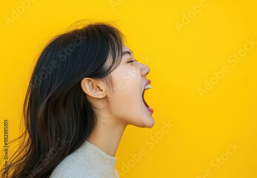 A Young Woman's Profile Against Vibrant Yellow, Open Mouth in a Shout, Long Dark Hair, Side View Portrait