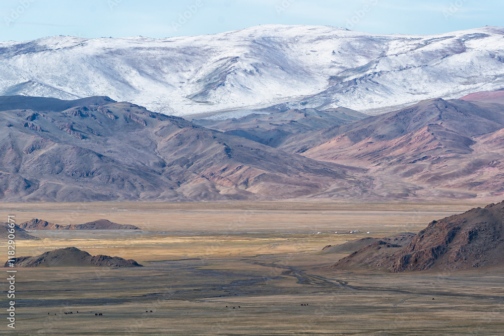Asia, Mongolia, Bayan-Olgii Province, Altai Mountains. Scenic view of the rugged mountains with grasslands in the foreground.