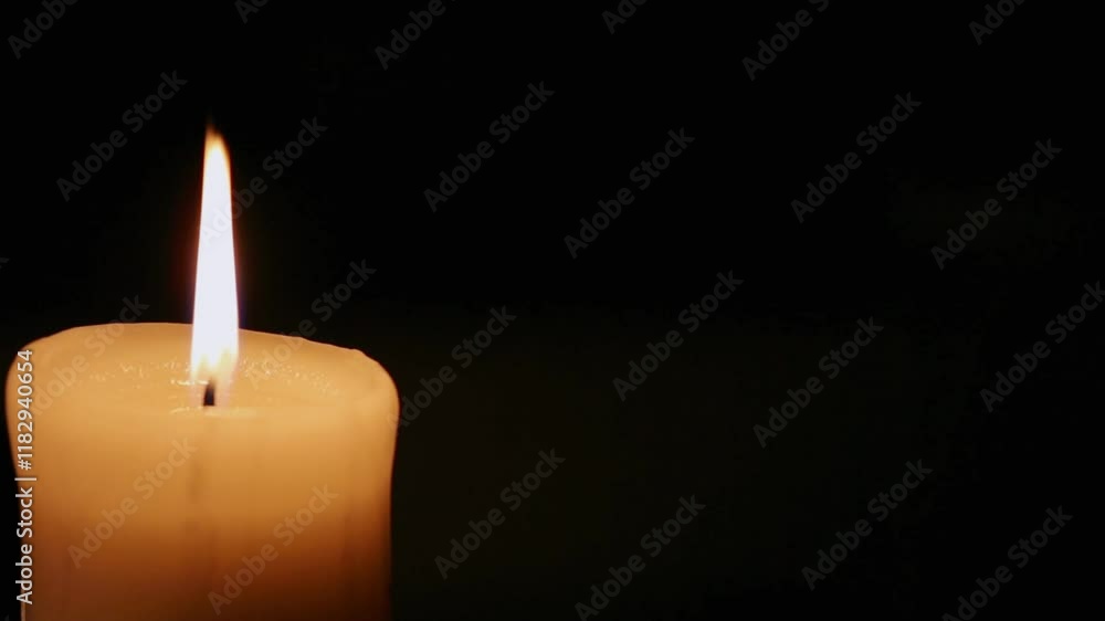 Closeup candle beautiful burning on dark black background with blur ...