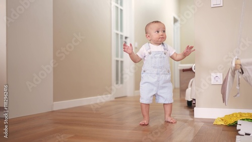 baby first steps. son a baby toddler learning to walk take first steps. happy family kid dream concept. baby indoors learning to walk indoors. lifestyle baby son training concept photo